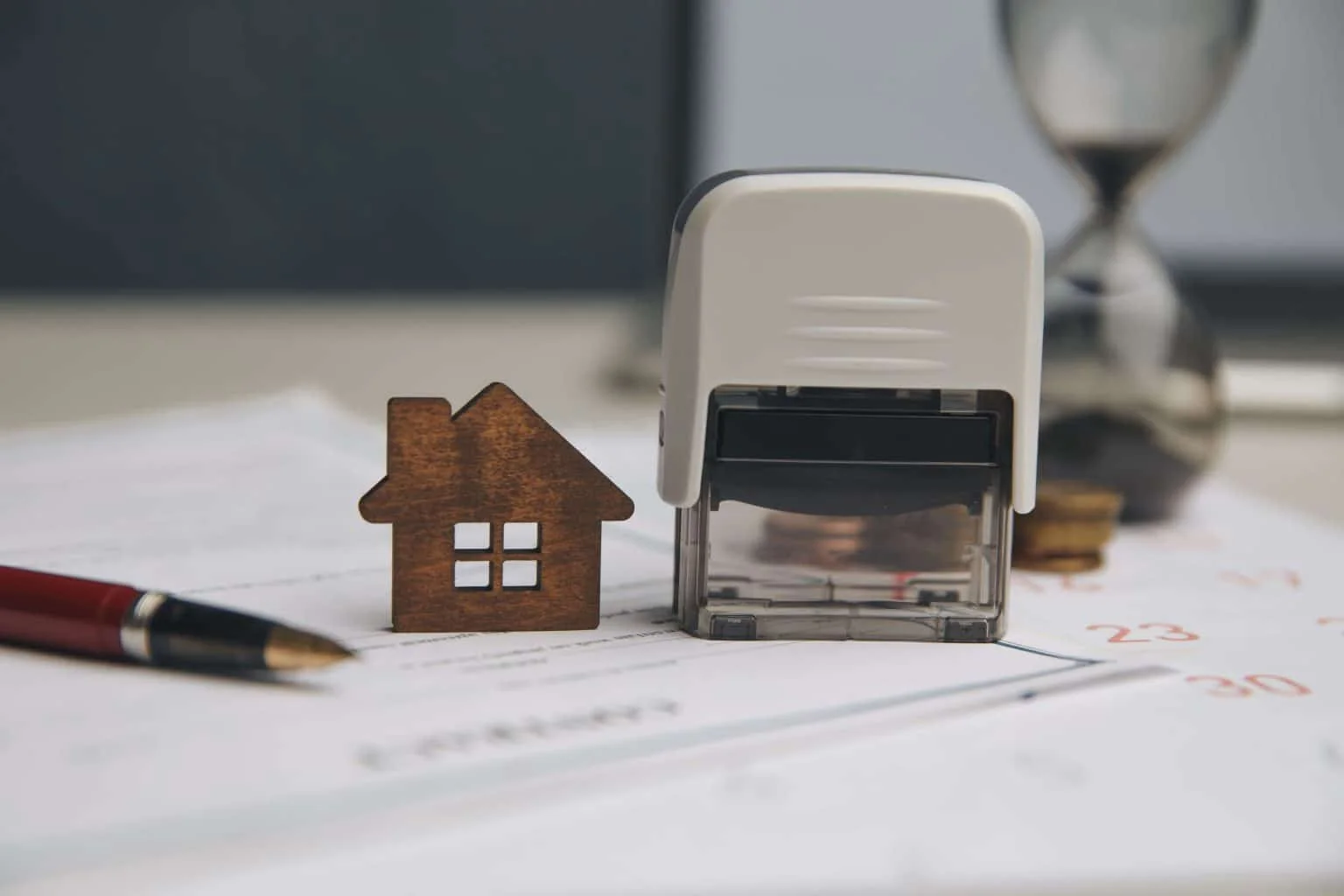Loan signing agent reviewing multiple mortgage document packages during a real estate closing appointment.